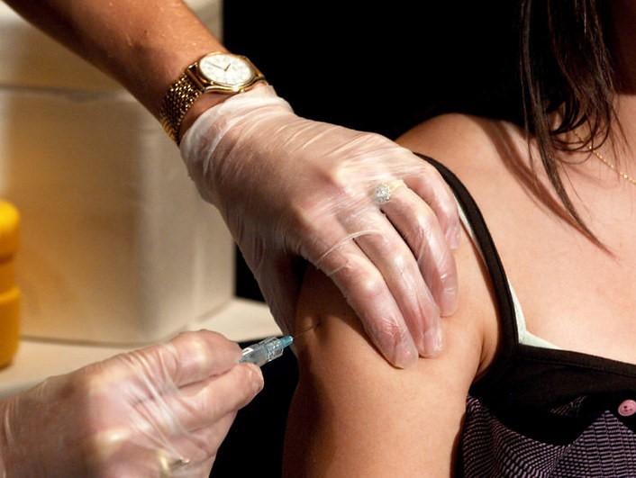 Girl receiving shot in arm