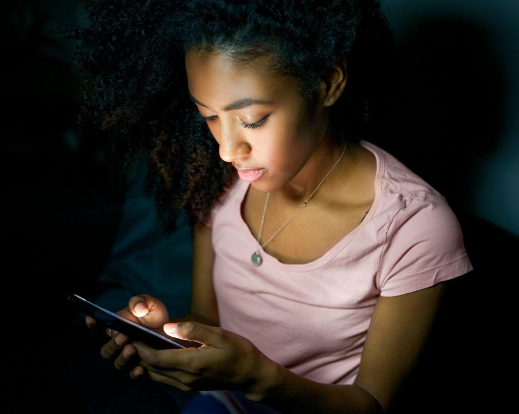 Girl on smartphone at night
