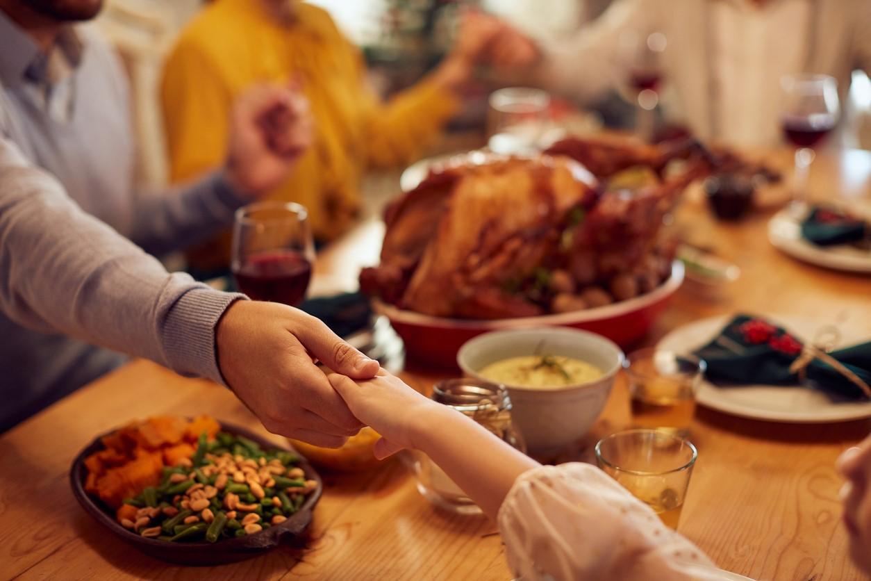 Family giving thanks at Thanksgiving