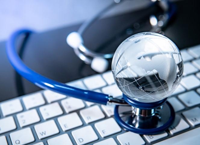 Globe and stethoscope on keyboard