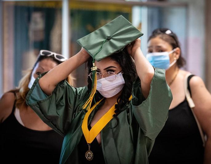 College graduate with mask