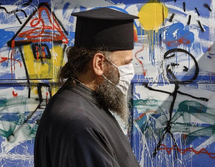 Greek Orthodox priest wearing mask in Athens