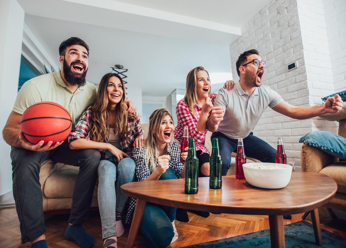 Group at home cheering on basketball team