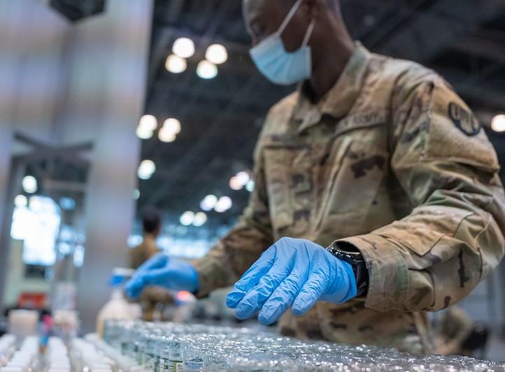 Guardsman with rows of vaccine vials