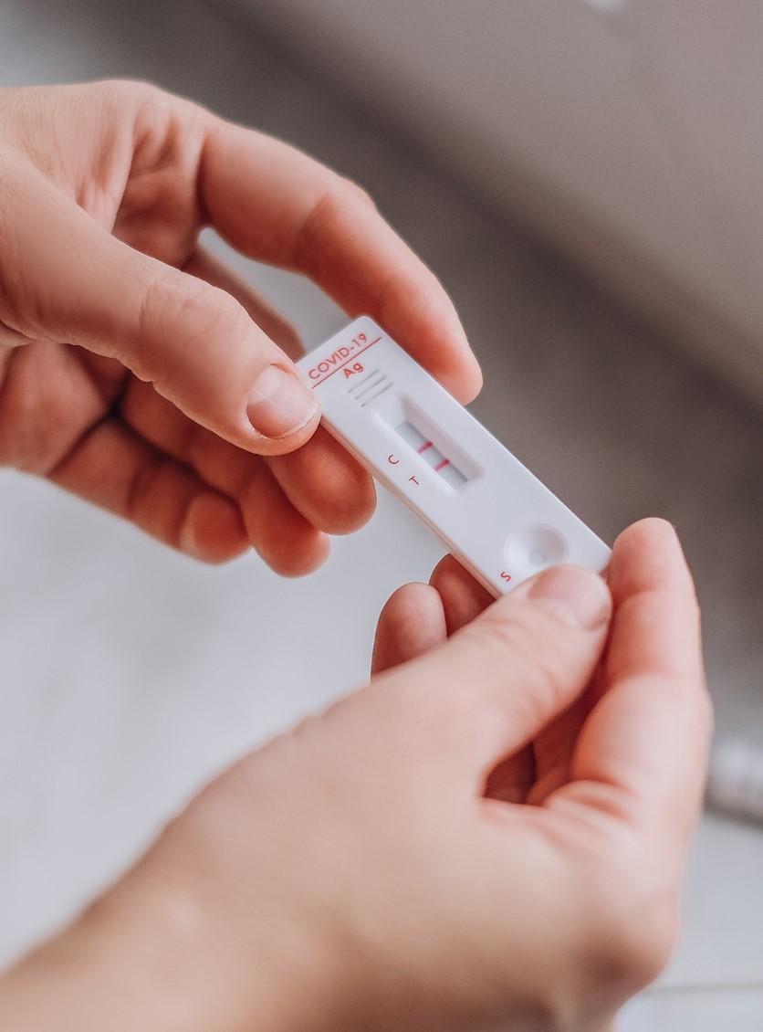Hands holding rapid COVID-19 test