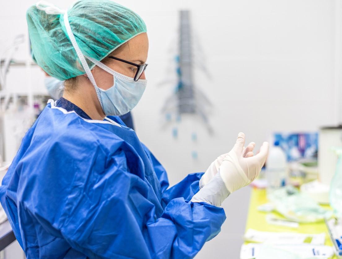 Healthcare worker putting on personal protective equipment