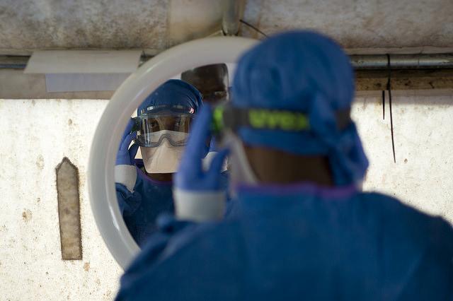 Health worker donning PPE