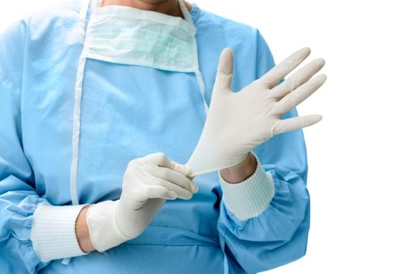 Health worker donning gloves