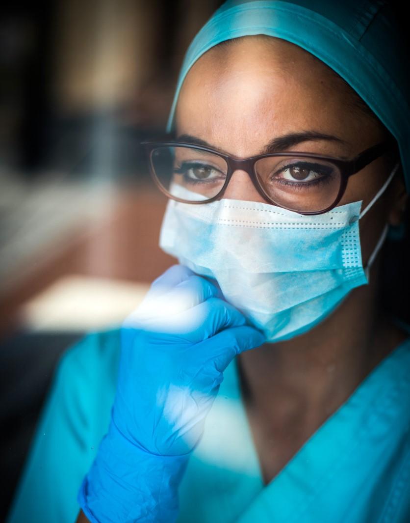 Healthcare worker wearing mask looking thoughtful