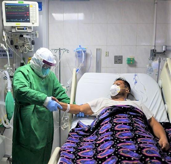 Doctor with hospitalized COVID-19 patient