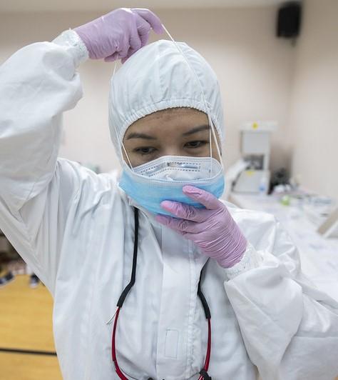 Indonesian healthcare worker donning PPE
