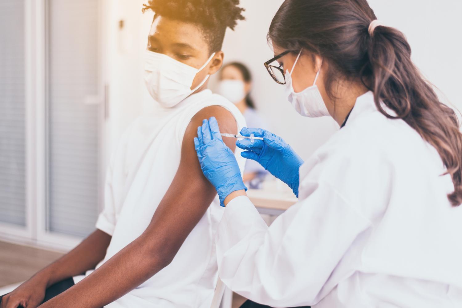 Boy getting COVID-19 vaccine