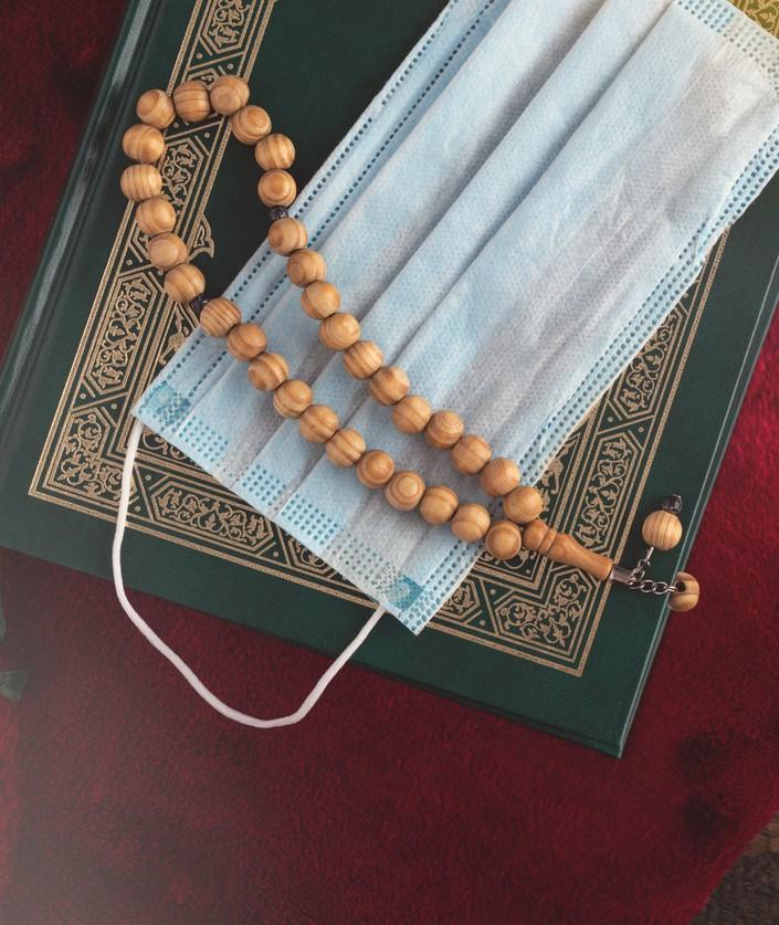 A Koran, mask, and prayer beads
