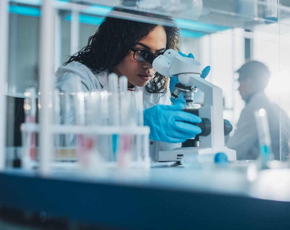 Lab scientist at microscope