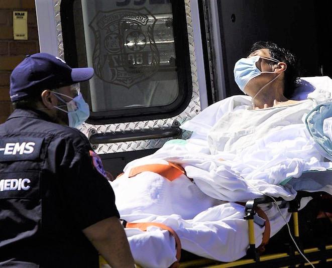Loading a COVID-19 patient onto an ambulance