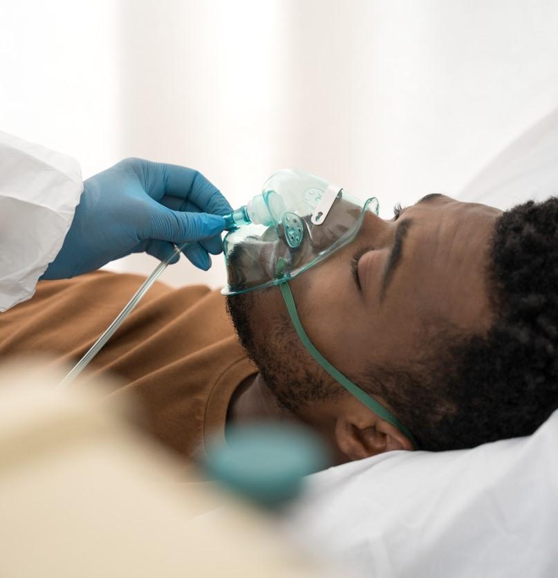 Man receiving oxygen mask in hospital