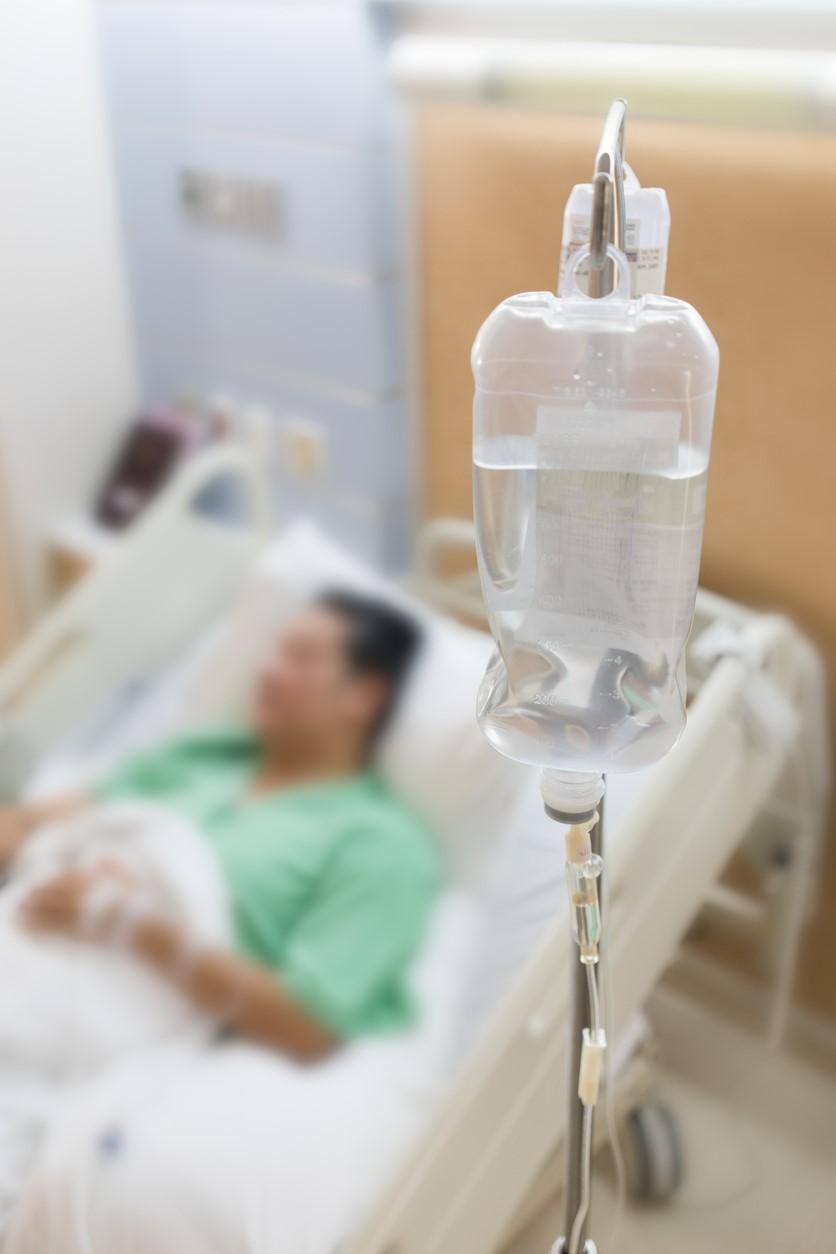 Man in hospital bed, blurred