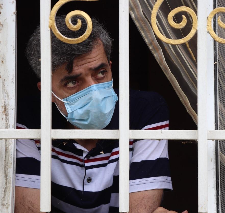 Man quarantined looking out window