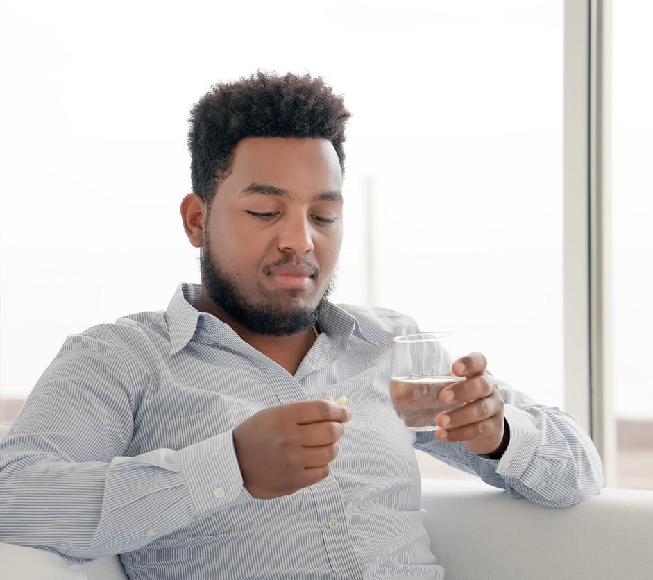 Man taking oral pill