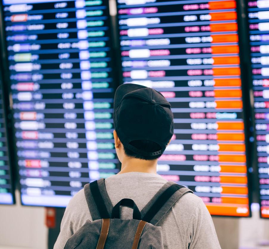 Man viewing airport flight board