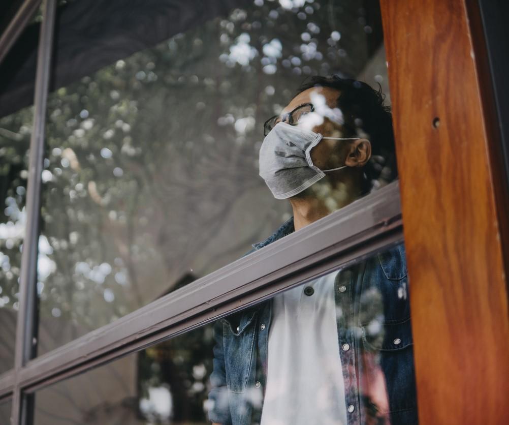 Man wearing mask in window