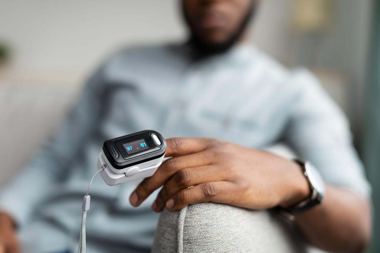 Man with pulse oximeter on finger