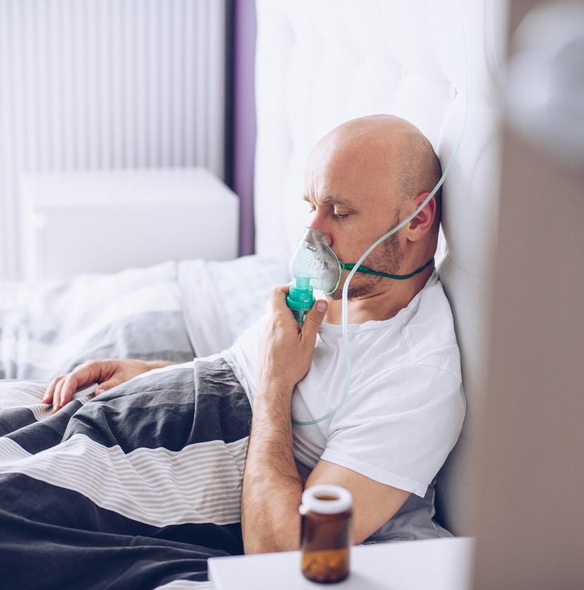 Man with oxygen mask in hospital