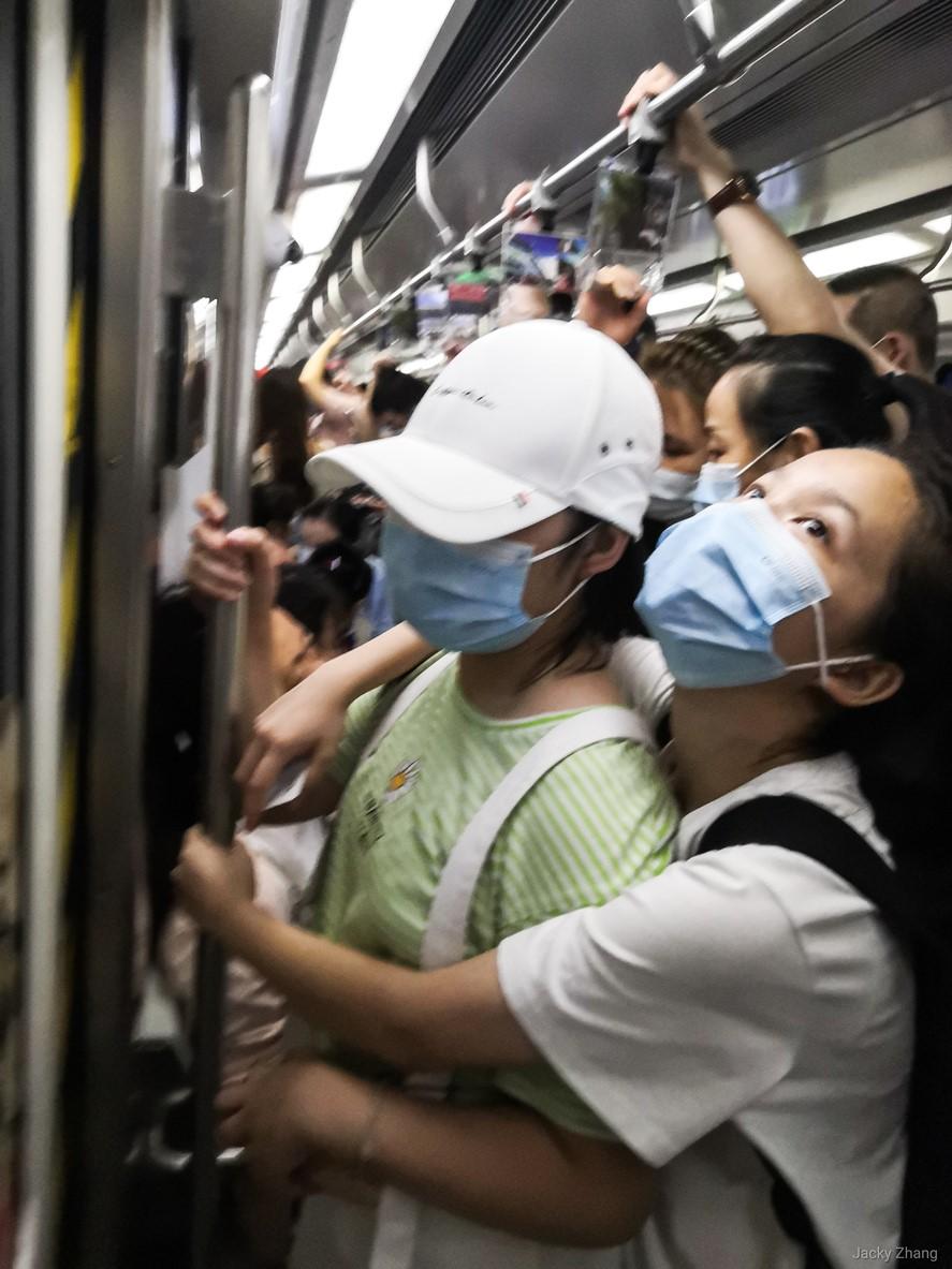 Masked people in a crowded subway