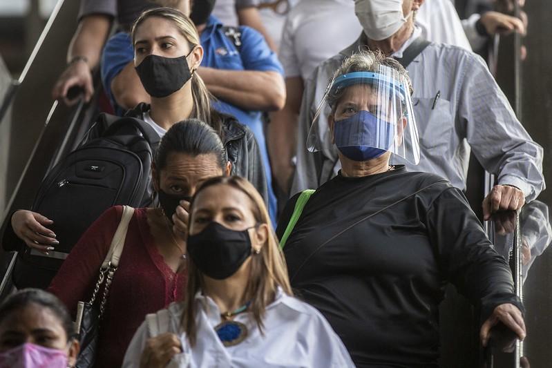 Masked Colombians on escalator