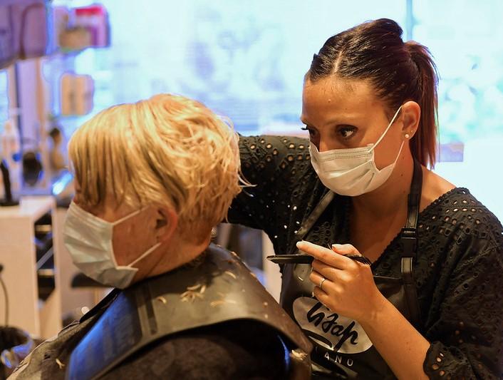 Hairdresser and client wearing masks