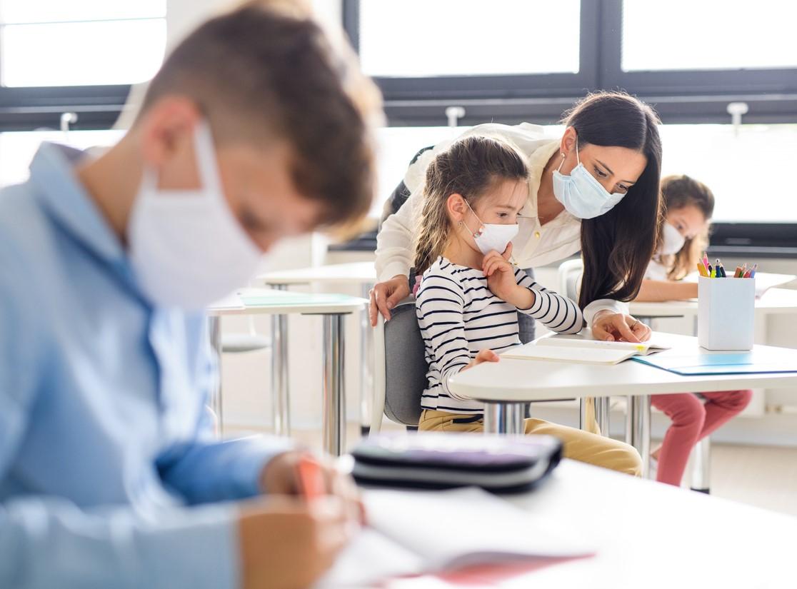 Students and teacher wearing masks in classroom