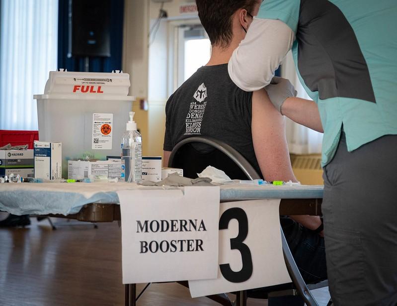 Moderna booster sign in vaccine clinic