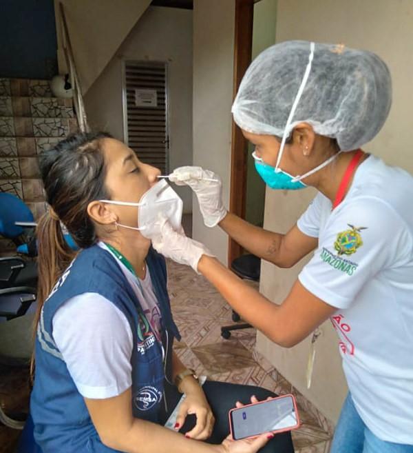 Health worker getting nasal swab