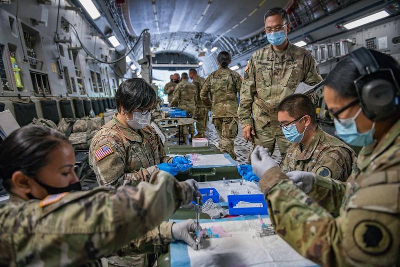 National Guard troops aboard airplane with COVID vaccine