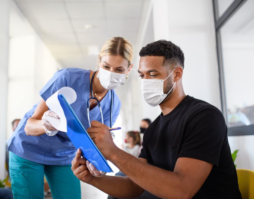 Nurse counseling man on vaccines