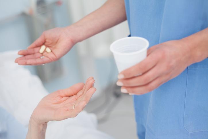 Nurse giving pills