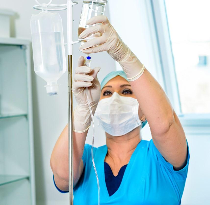 Nursing hanging an IV drip