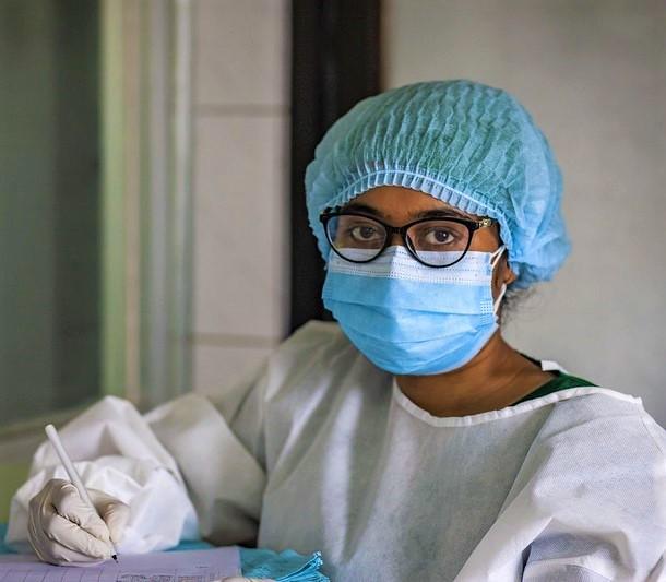 Nurse wearing mask, cap, and gloves