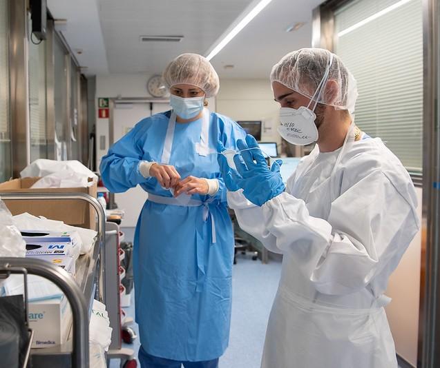Nurses putting on protective equipment