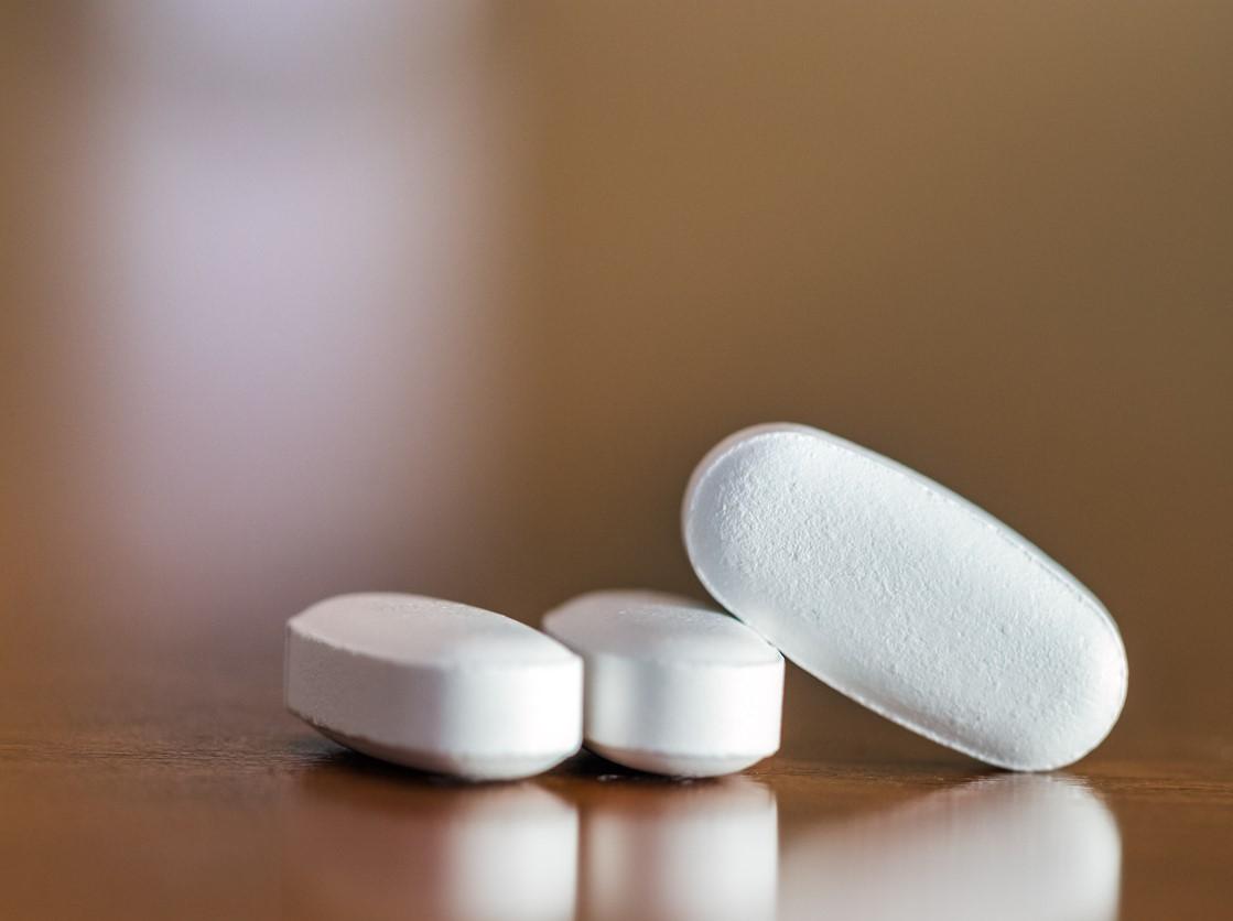 Three oblong white pills