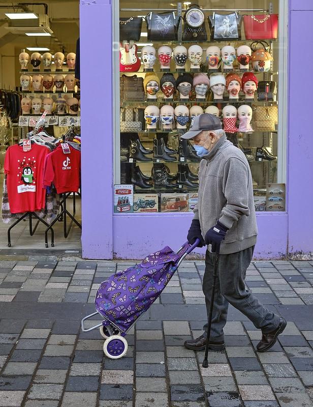 Old man wearing mask in street