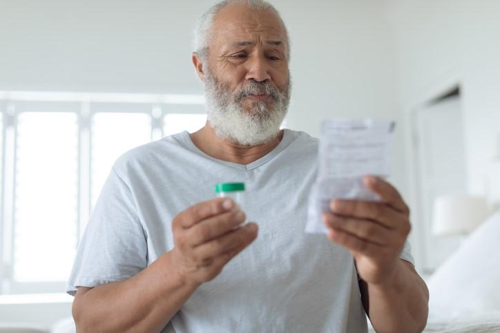 Older man reading prescription