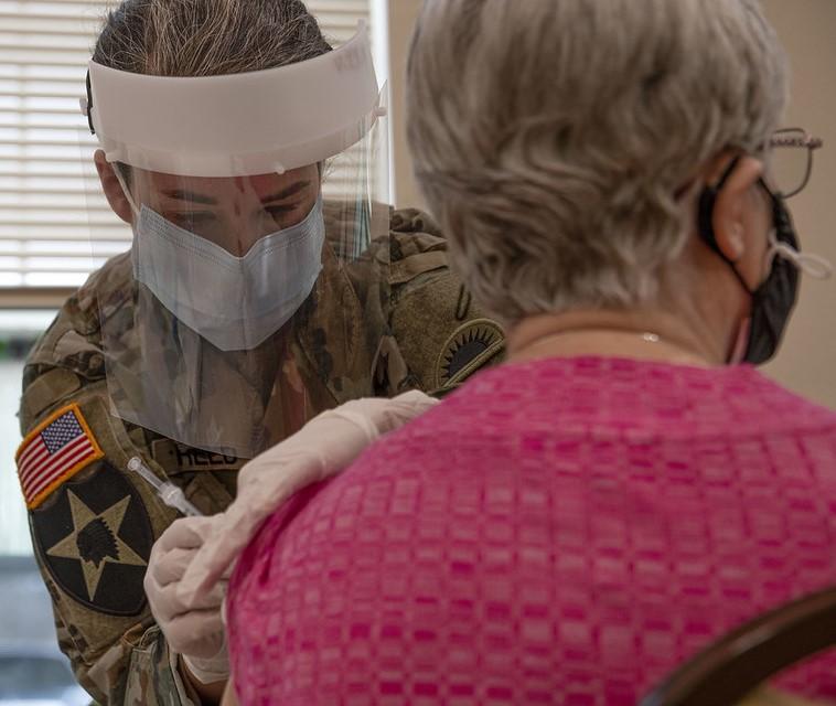 Older woman receiving COVID-19 vaccine