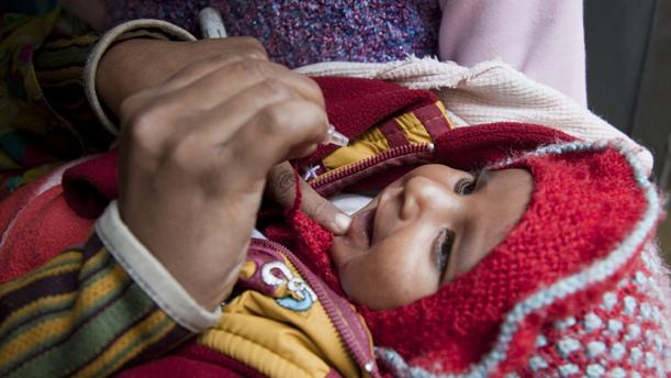 Child receiving oral polio vaccine