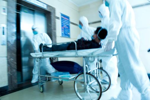 Patient being rushed through hospital on gurney