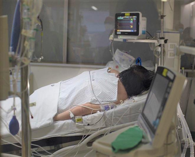Patient lying prone in hospital bed
