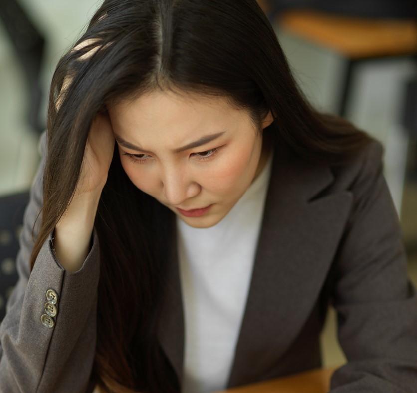 Pensive woman at laptop