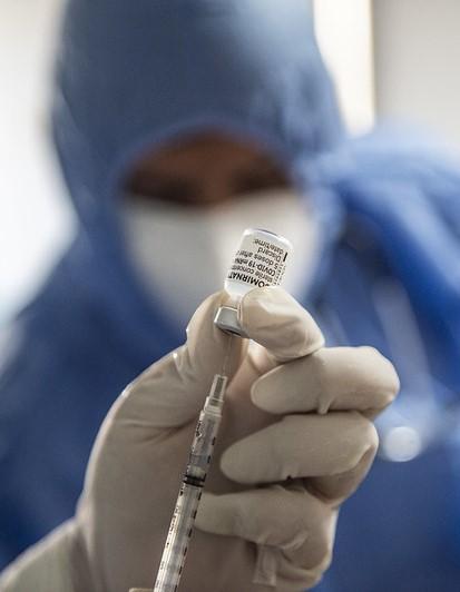 Pfizer COVID vaccine vial and syringe