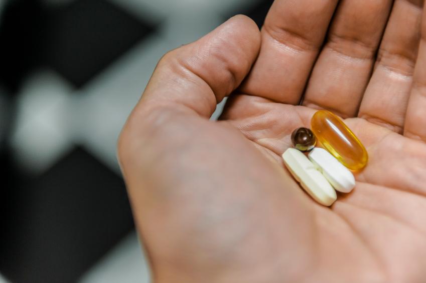 Hand with pills/capsules
