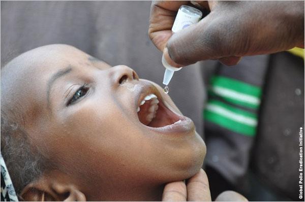 An African child is given oral polio vaccine.